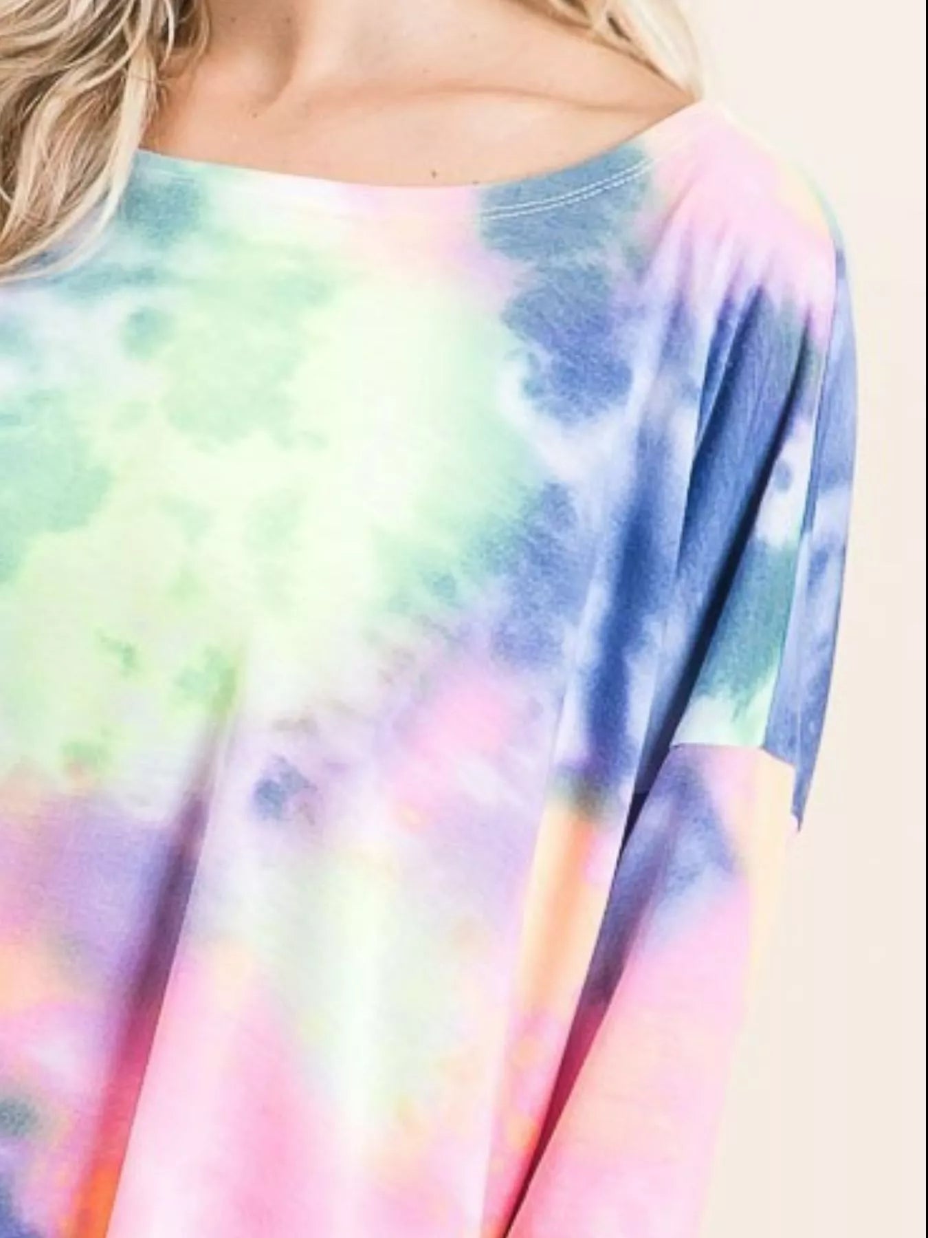 Sarah Express women’s oversized low gauge knit top with a colorful tie-dye print.