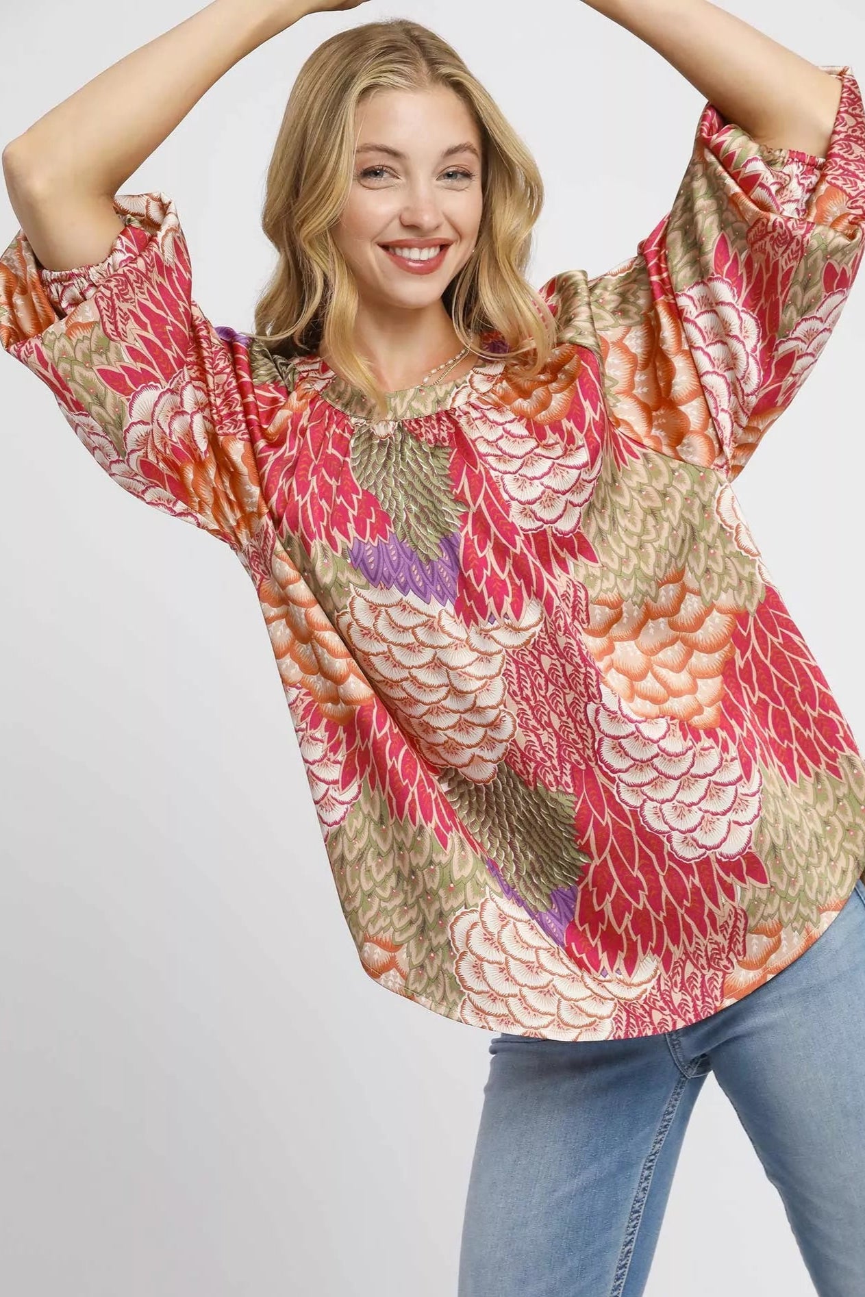 Sarah Express women’s oversized boho peasant blouse with a whimsical feather print and flowy sleeves.