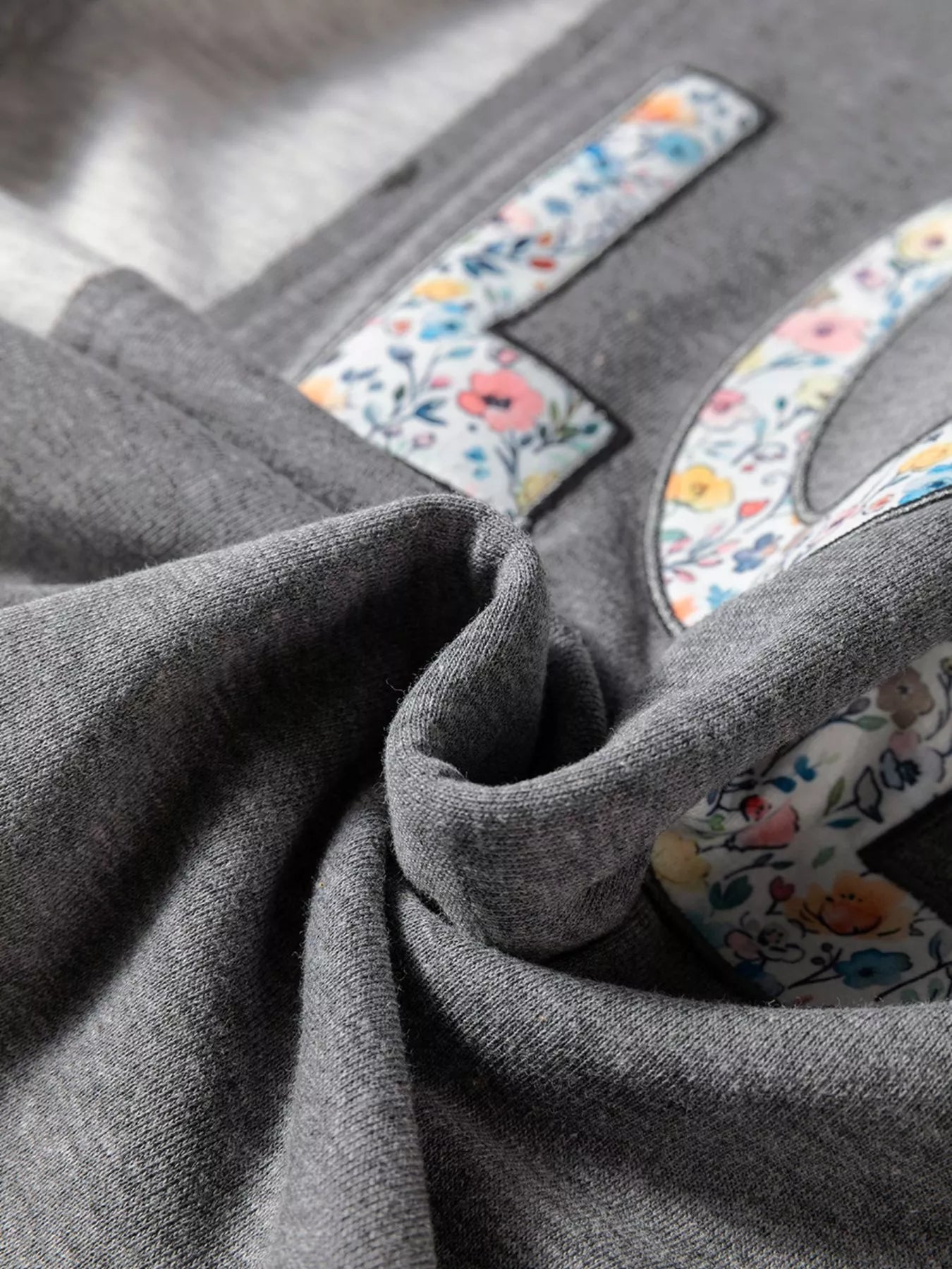 Sarah Express Women's LOVE Graphic Exposed Seam Patchwork Uneven Hem Chic Sweatshirt