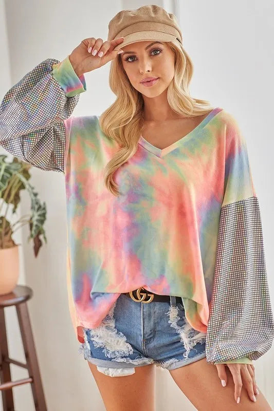 Sarah Express women’s oversized tie-dye French terry top with a V-neck and shimmer details.
