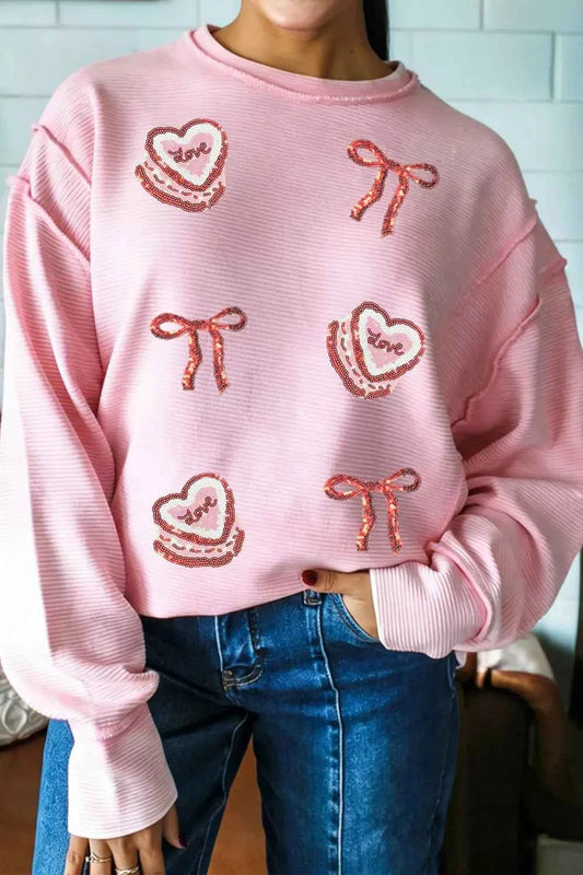 Sarah Express Women's Sequin Love Cake Bow Graphic Long Sleeve Top - Ribbed Texture Exposed Seam Blush Pink