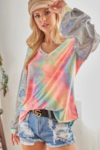 Sarah Express women’s oversized tie-dye French terry top with a V-neck and shimmer details.
