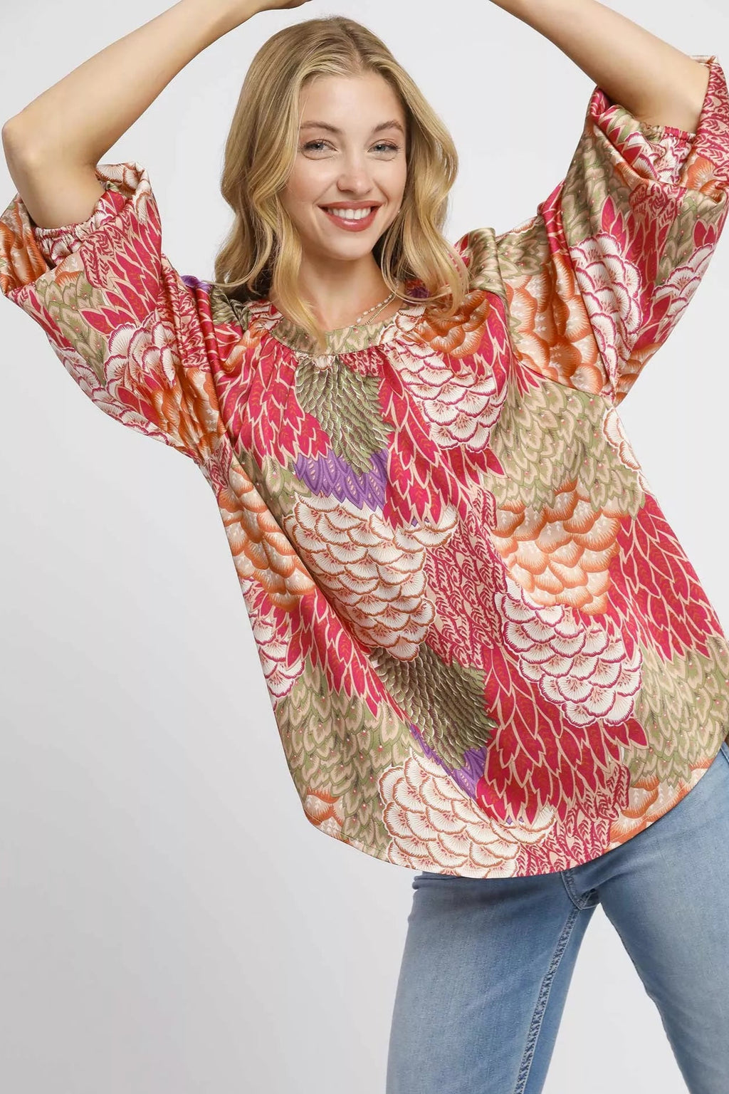 Sarah Express women’s oversized boho peasant blouse with a whimsical feather print and flowy sleeves.
